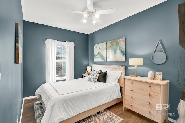 bedroom with ceiling fan, crown molding, and dark hardwood / wood-style flooring