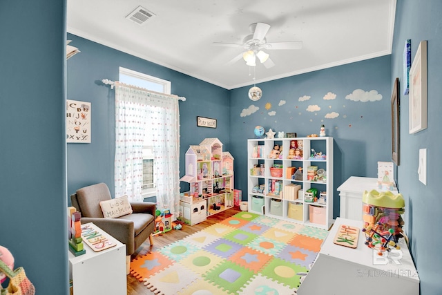 game room featuring ceiling fan, crown molding, and wood-type flooring