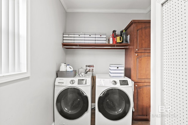 washroom with cabinets, washing machine and clothes dryer, and crown molding