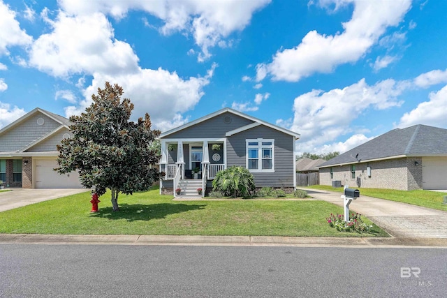 view of front of house featuring central AC, a garage, covered porch, and a front yard