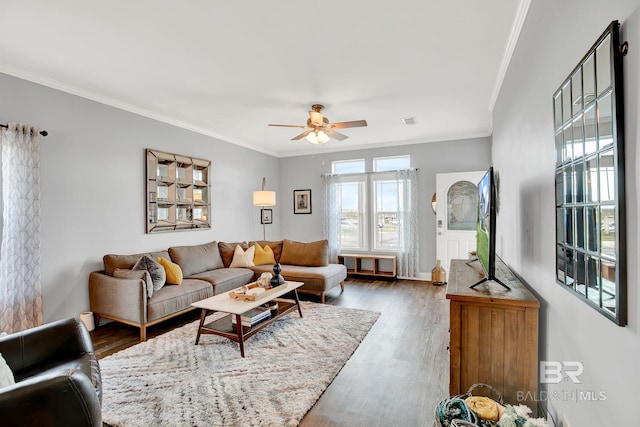 living room featuring crown molding, dark hardwood / wood-style floors, and ceiling fan