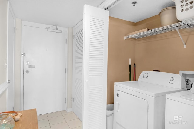 laundry area featuring light tile patterned flooring, laundry area, and separate washer and dryer