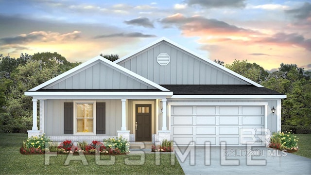 view of front of property featuring a garage, covered porch, and a lawn