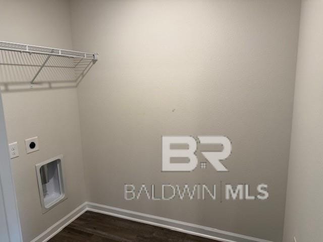 clothes washing area with dark wood-type flooring and hookup for an electric dryer