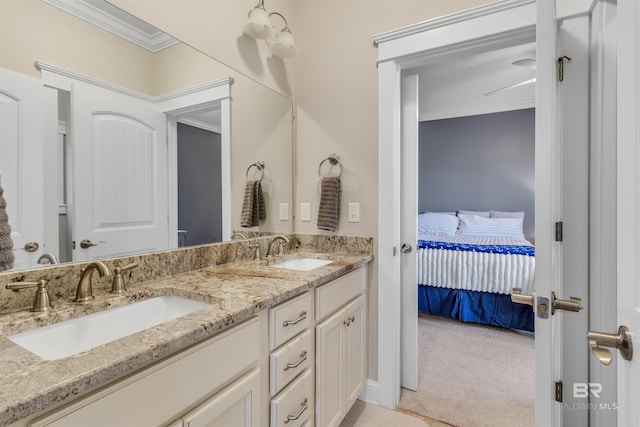 ensuite bathroom featuring double vanity, ornamental molding, a sink, and ensuite bathroom