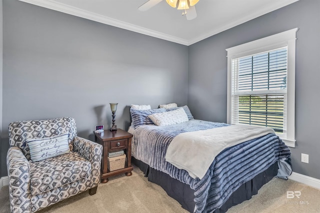 carpeted bedroom with ornamental molding, ceiling fan, and baseboards