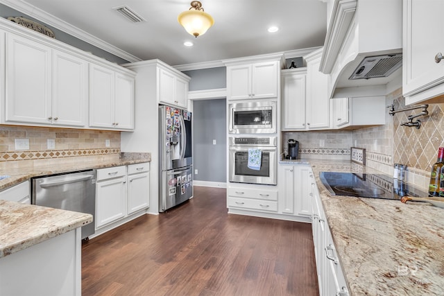 kitchen with stainless steel appliances, premium range hood, white cabinetry, light stone countertops, and dark wood-style floors