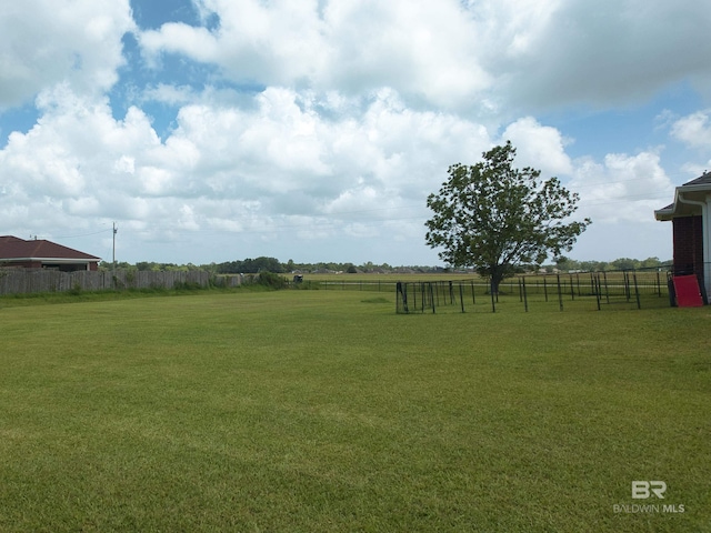 view of yard featuring a rural view and fence