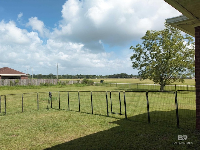 view of yard featuring fence and a rural view