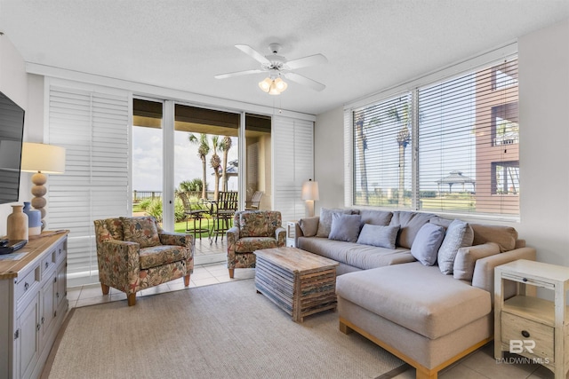 527 Beach Club Trl Unit C110, Gulf Shores, AL 36542 - living area featuring ceiling fan, light tile patterned flooring, and a textured ceiling