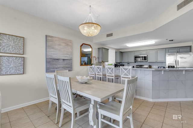 527 Beach Club Trl Unit C110, Gulf Shores, AL 36542 - dining space featuring a chandelier and light tile patterned floors