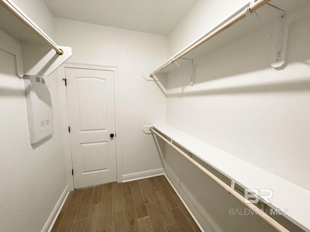 walk in closet featuring wood finish floors