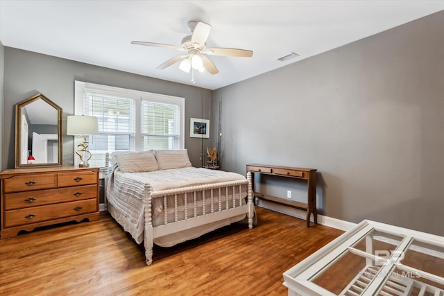 bedroom with ceiling fan and wood-type flooring