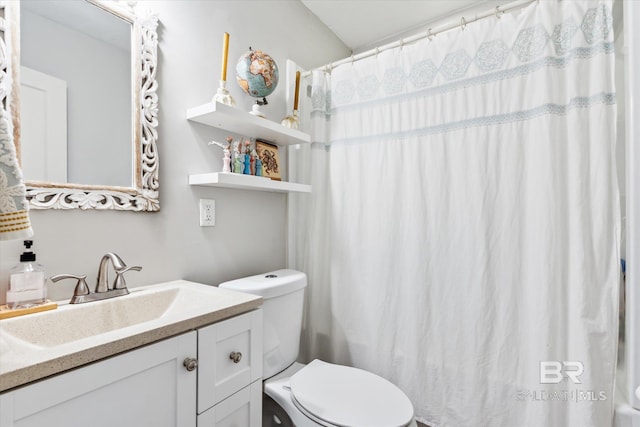 bathroom with vanity, curtained shower, and toilet