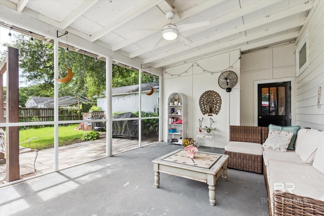 unfurnished sunroom featuring beam ceiling