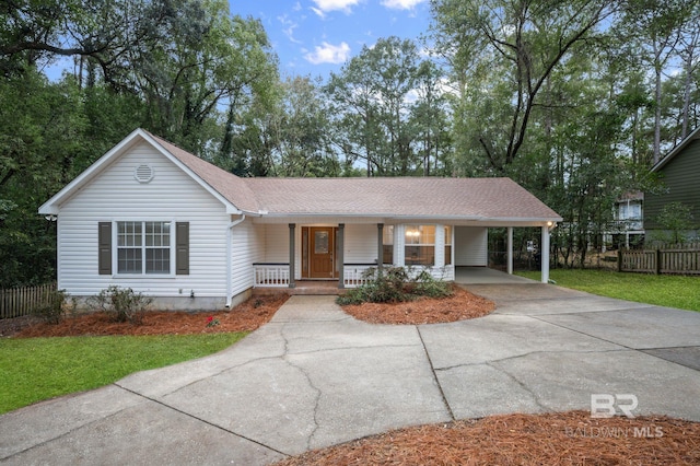 ranch-style house with a porch, a carport, and a front lawn