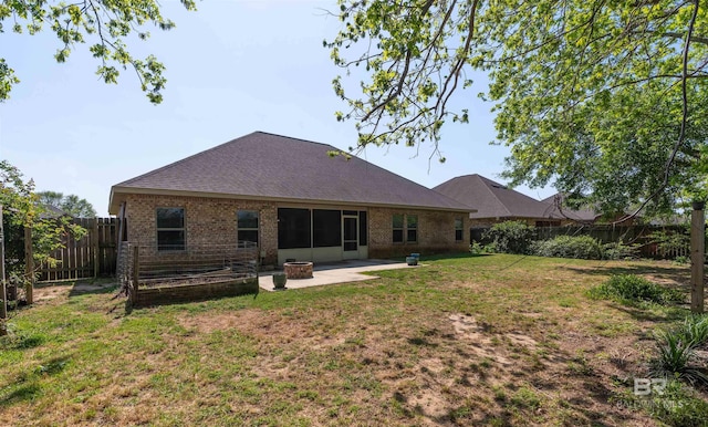 343 Stave Mill Rd, Fairhope, AL 36532 - back of property featuring a lawn, an outdoor fire pit, a fenced backyard, a patio, and brick siding