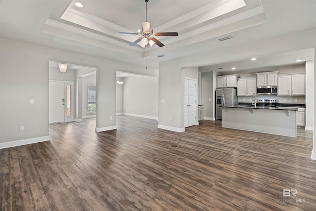 343 Stave Mill Rd, Fairhope, AL 36532 - unfurnished living room with crown molding, dark wood-style flooring, and a tray ceiling