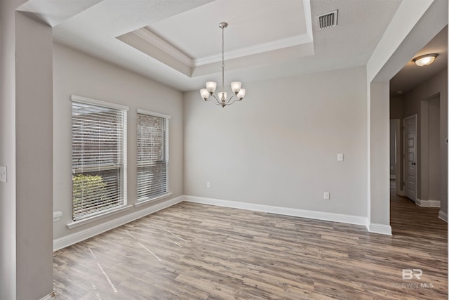 343 Stave Mill Rd, Fairhope, AL 36532 - spare room with wood finished floors, a tray ceiling, baseboards, ornamental molding, and visible vents