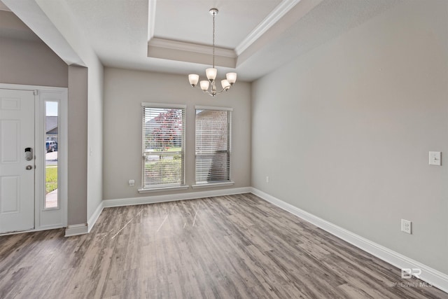 343 Stave Mill Rd, Fairhope, AL 36532 - unfurnished dining area featuring a tray ceiling, wood finished floors, ornamental molding, baseboards, and a chandelier