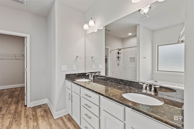 343 Stave Mill Rd, Fairhope, AL 36532 - bathroom with wood finished floors, a sink, a shower stall, and a walk in closet