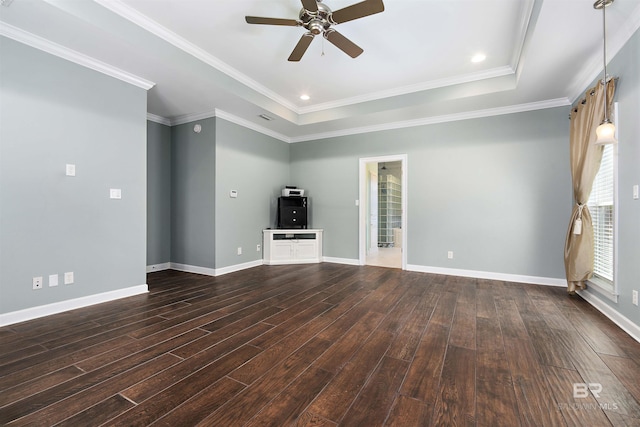 unfurnished living room with crown molding, a tray ceiling, and dark hardwood / wood-style floors