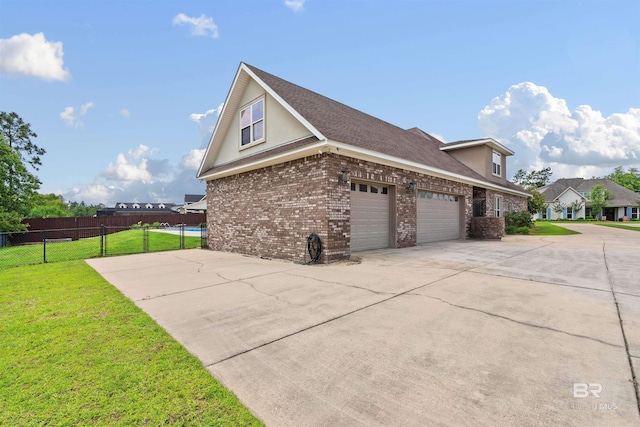 view of side of home featuring a yard and a garage