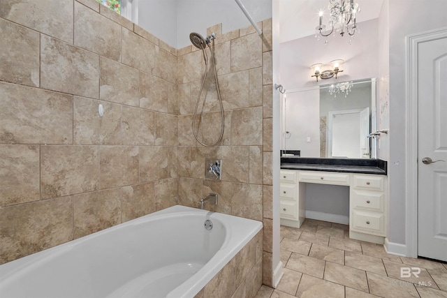 bathroom featuring tiled shower / bath, tile flooring, vanity, and a notable chandelier