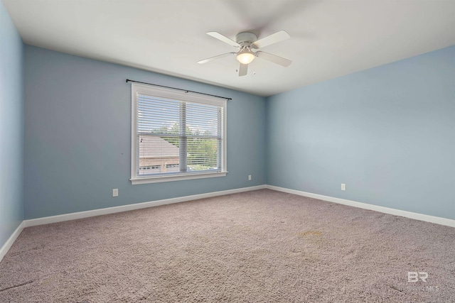 unfurnished room featuring ceiling fan and carpet