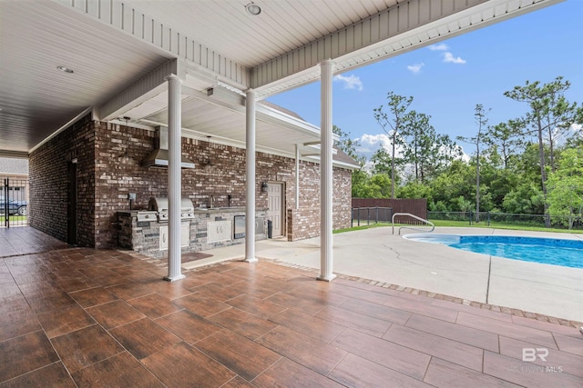 view of swimming pool featuring a patio and a grill