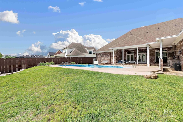 view of yard featuring a fenced in pool and a patio