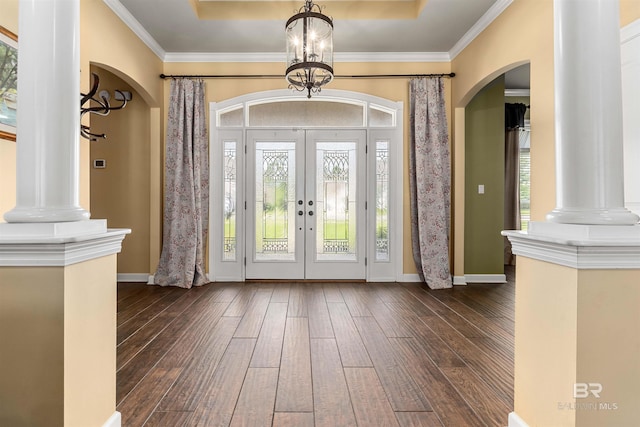 foyer with a chandelier, crown molding, dark hardwood / wood-style flooring, and a tray ceiling