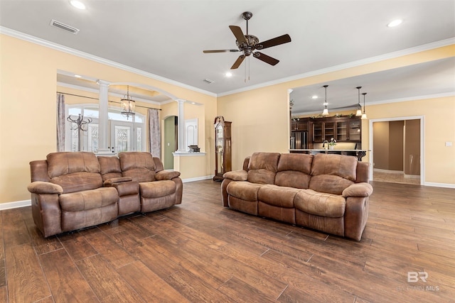 living room featuring ornamental molding, ceiling fan, ornate columns, and dark wood-type flooring