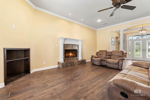 living room featuring ornamental molding, ceiling fan, hardwood / wood-style flooring, and a premium fireplace