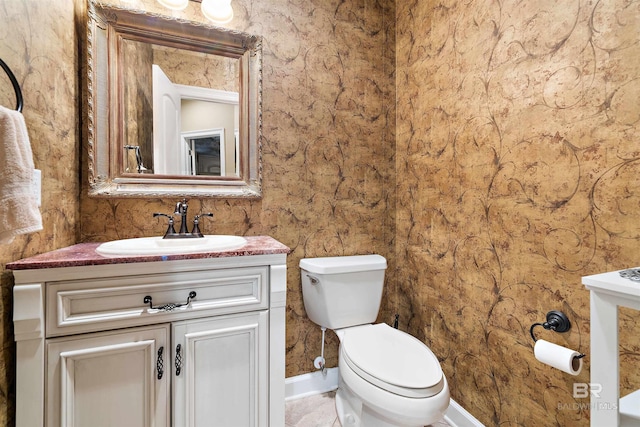 bathroom with toilet, oversized vanity, and tile flooring