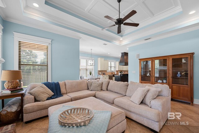 living area featuring ceiling fan with notable chandelier, recessed lighting, ornamental molding, and light tile patterned flooring