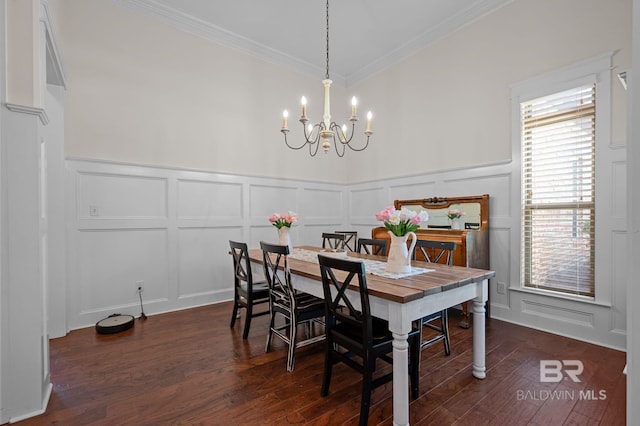 dining space with a decorative wall, ornamental molding, a chandelier, and dark wood-type flooring