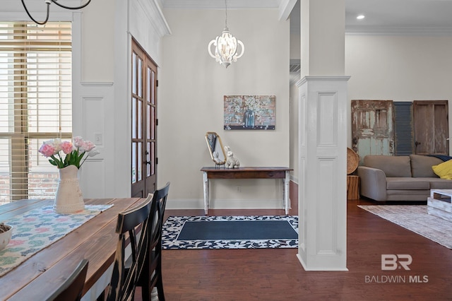 interior space with crown molding, wood finished floors, and a chandelier