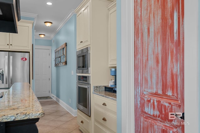 kitchen featuring light stone counters, light tile patterned flooring, appliances with stainless steel finishes, baseboards, and ornamental molding