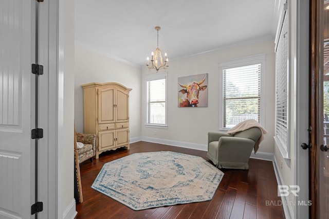 living area with dark wood-type flooring, baseboards, ornamental molding, and an inviting chandelier