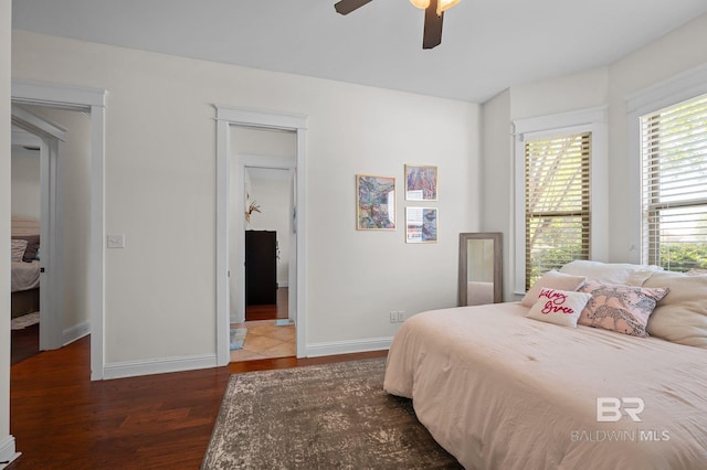 bedroom with baseboards, wood finished floors, and ceiling fan