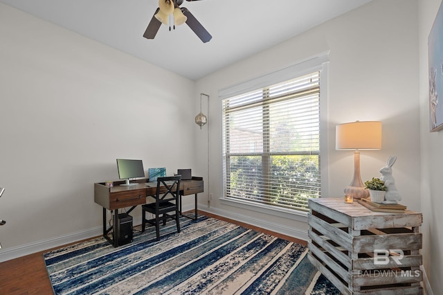 office area with baseboards, a ceiling fan, and wood finished floors