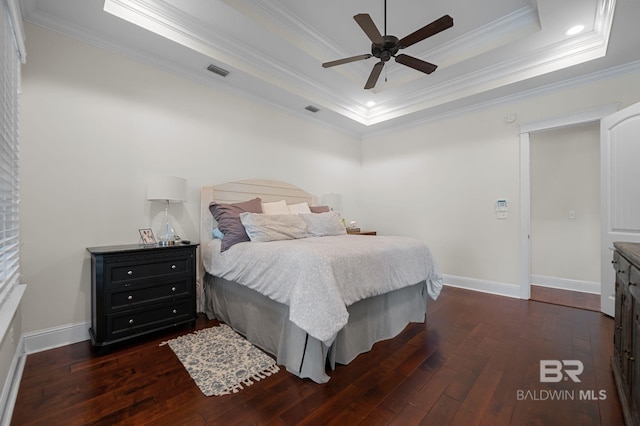 bedroom featuring baseboards, visible vents, dark wood-type flooring, and ornamental molding