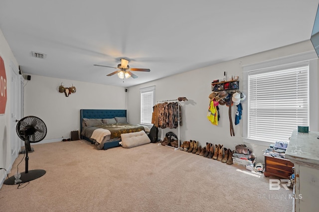 bedroom featuring a ceiling fan, carpet flooring, and visible vents