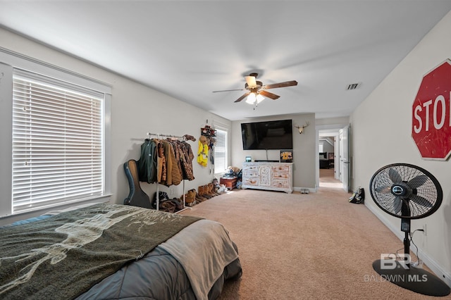 bedroom featuring visible vents, carpet flooring, baseboards, and a ceiling fan