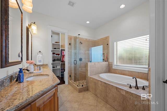 full bath with a shower stall, a garden tub, vanity, tile patterned flooring, and visible vents