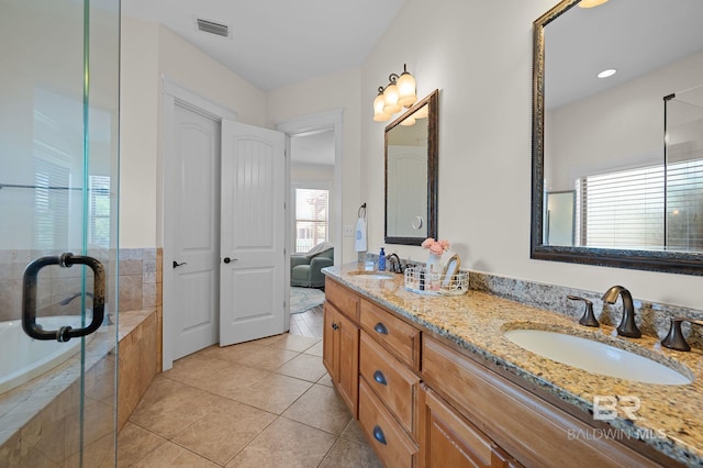 full bathroom featuring tile patterned floors, visible vents, a sink, and double vanity