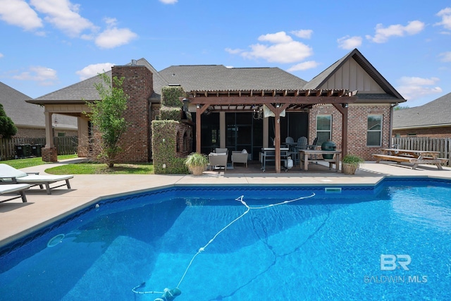 view of swimming pool featuring a pergola, fence, a patio, and a fenced in pool
