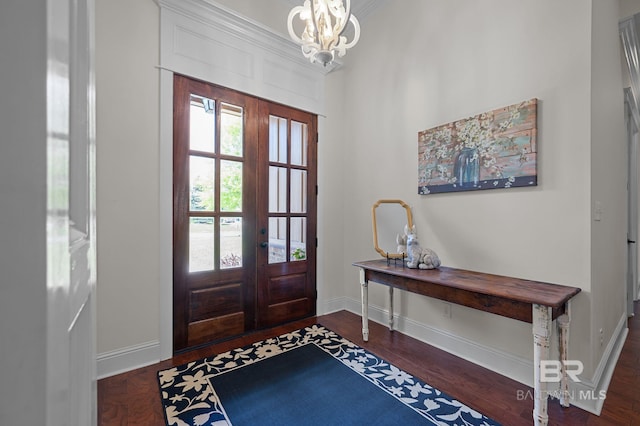 entryway with baseboards, french doors, wood finished floors, and a chandelier