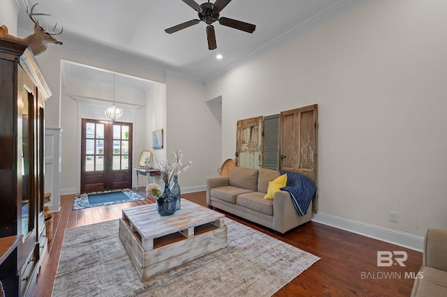living area with recessed lighting, ornamental molding, dark wood-type flooring, baseboards, and ceiling fan with notable chandelier